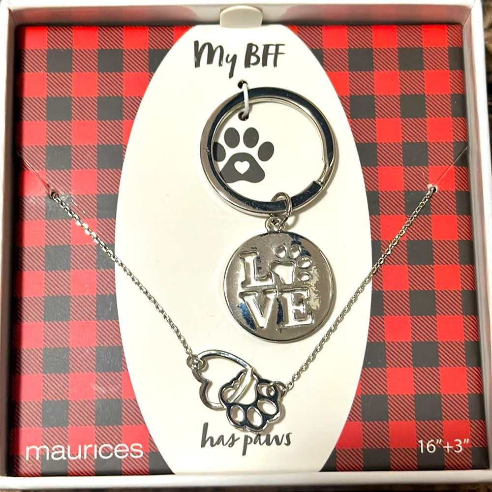 Necklace and key chain that are puppy themed in silver originally from Maurice’s